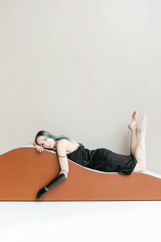 woman lying on a wooden plank and looking at camera