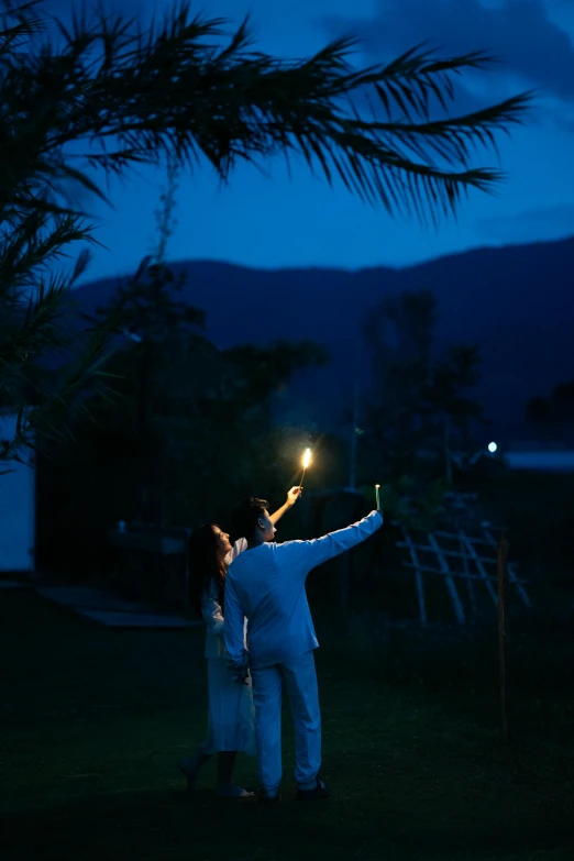 a man and woman that are standing in the grass