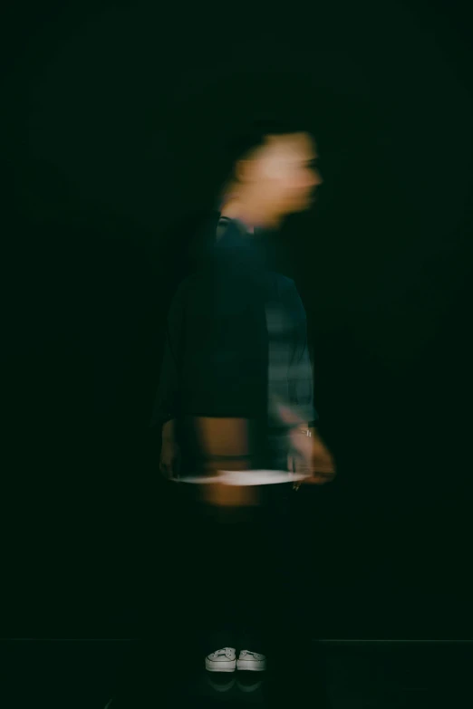 the blurry image of a person standing up