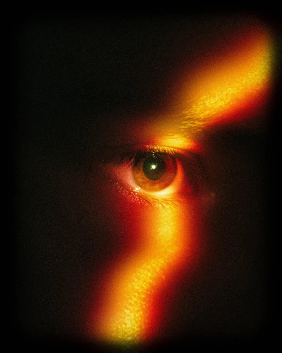 the eye of an adult with bright orange lights on it