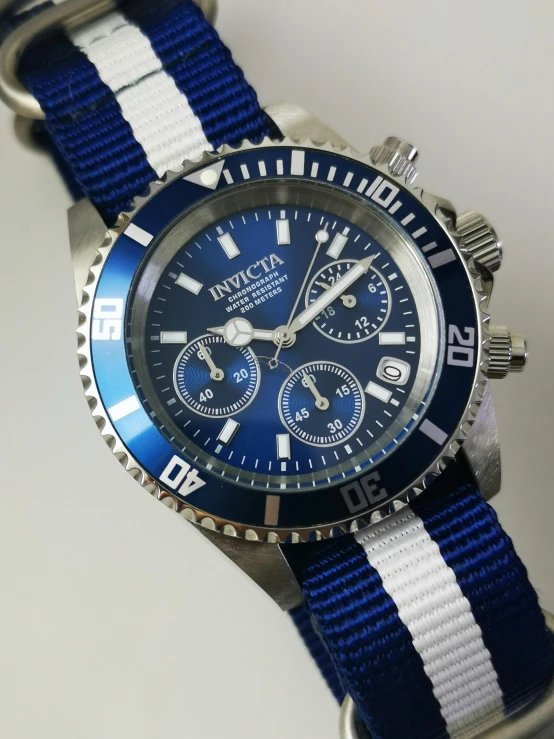 the watch is blue and white on the strap