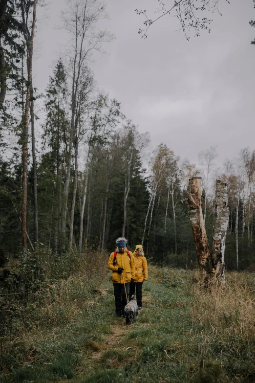 two people walk together through the woods