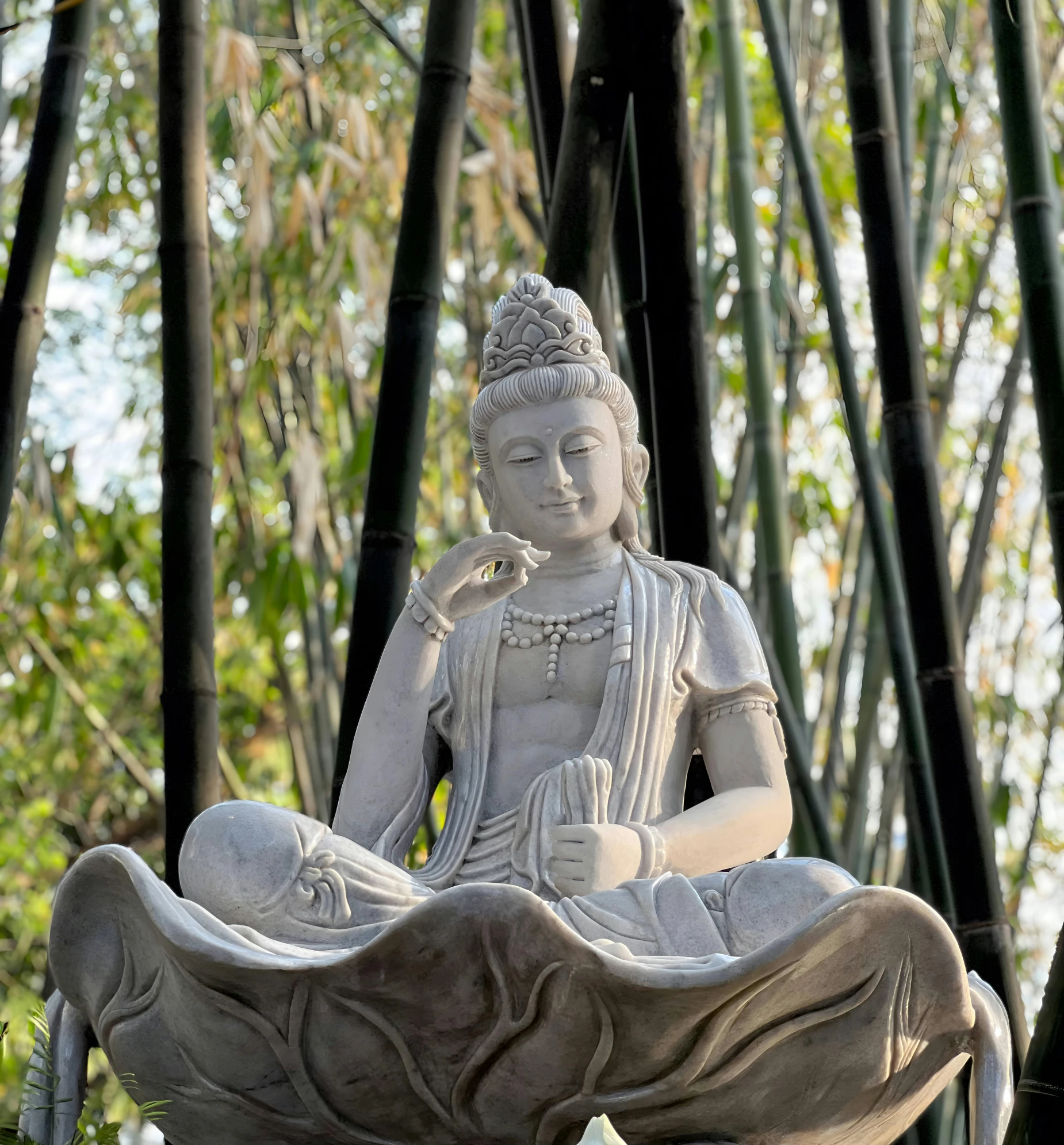a small buddha statue sits on the side of a rock