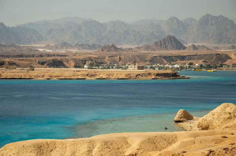 a landscape of mountains and rivers with blue water