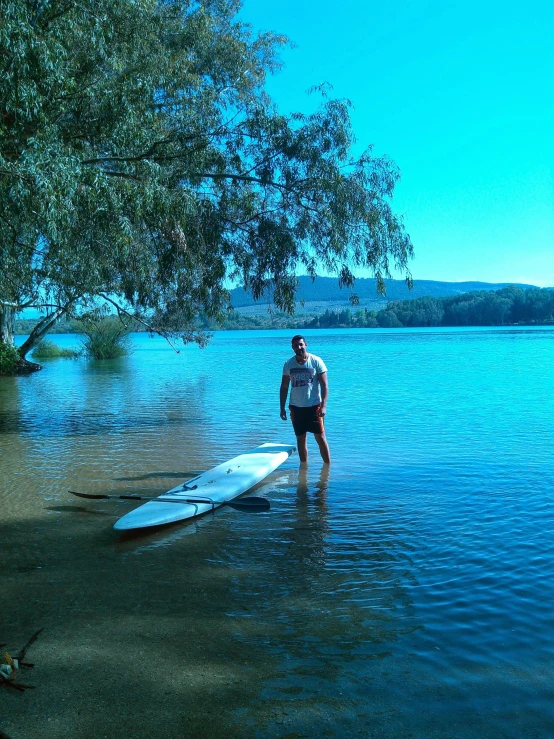 a man standing on a surf board in the water