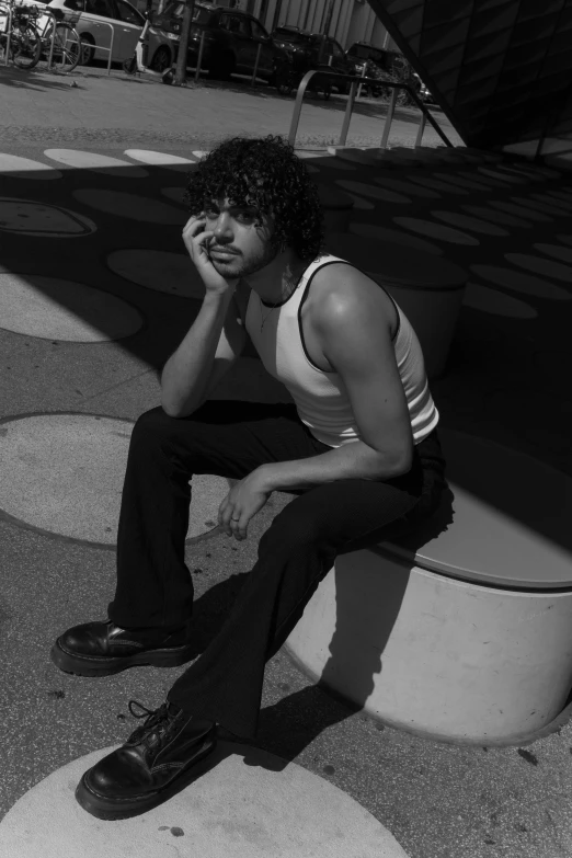 a man sitting on a bench next to a staircase