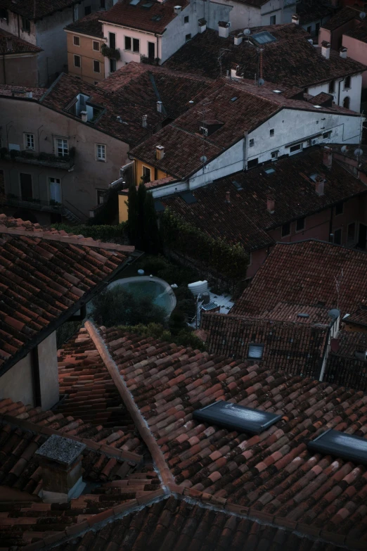 a rooftop with some tall buildings and a street light in the background