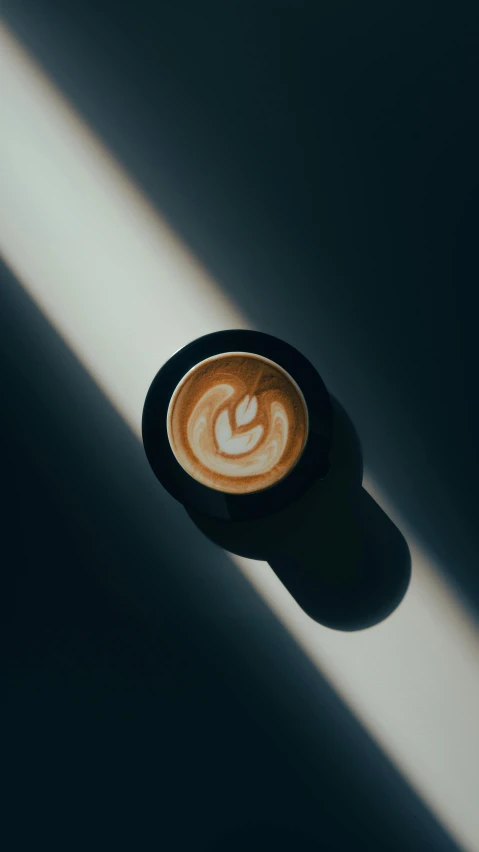 coffee latte in the shape of a smiling face is on a dark background