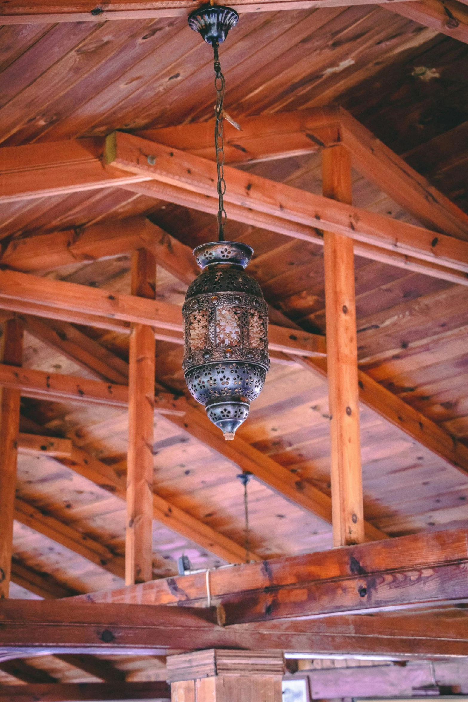 a lantern hanging from the ceiling in an old style house