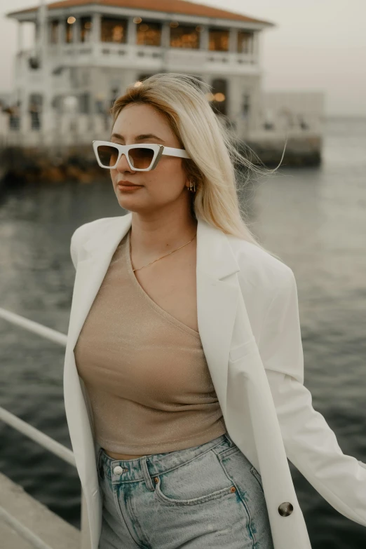 a woman in white glasses standing on the deck