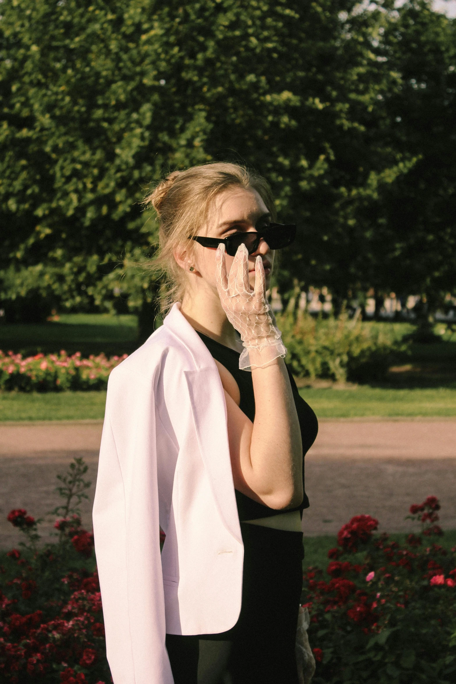 a woman wearing black glasses and a white coat