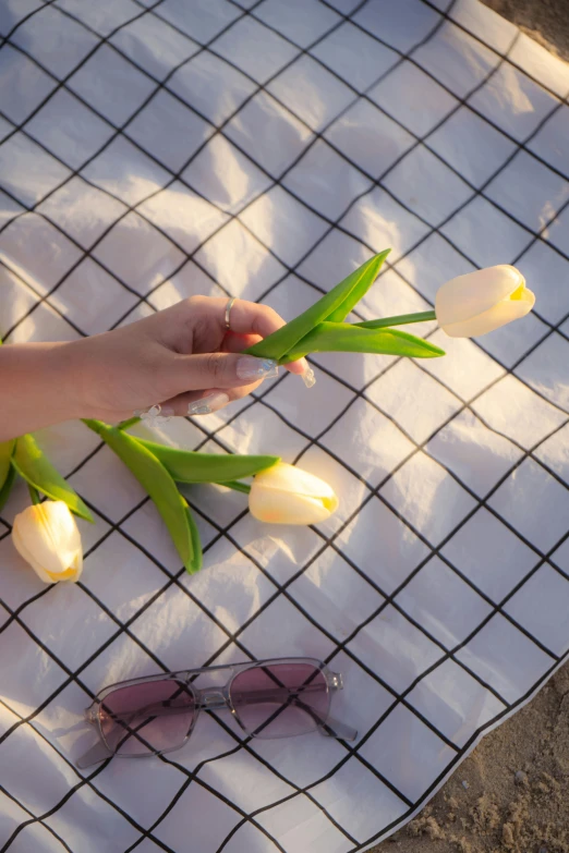 a woman is placing the flowers to place in a vase