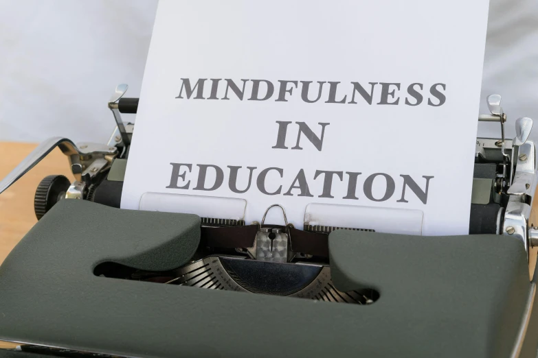 an old typewriter with an unplugged paper reading mindfulness in education