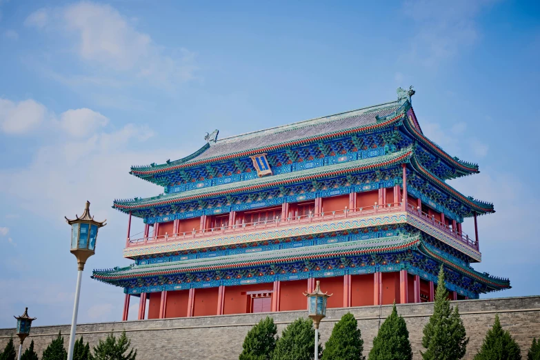 a tall asian building in front of a blue sky