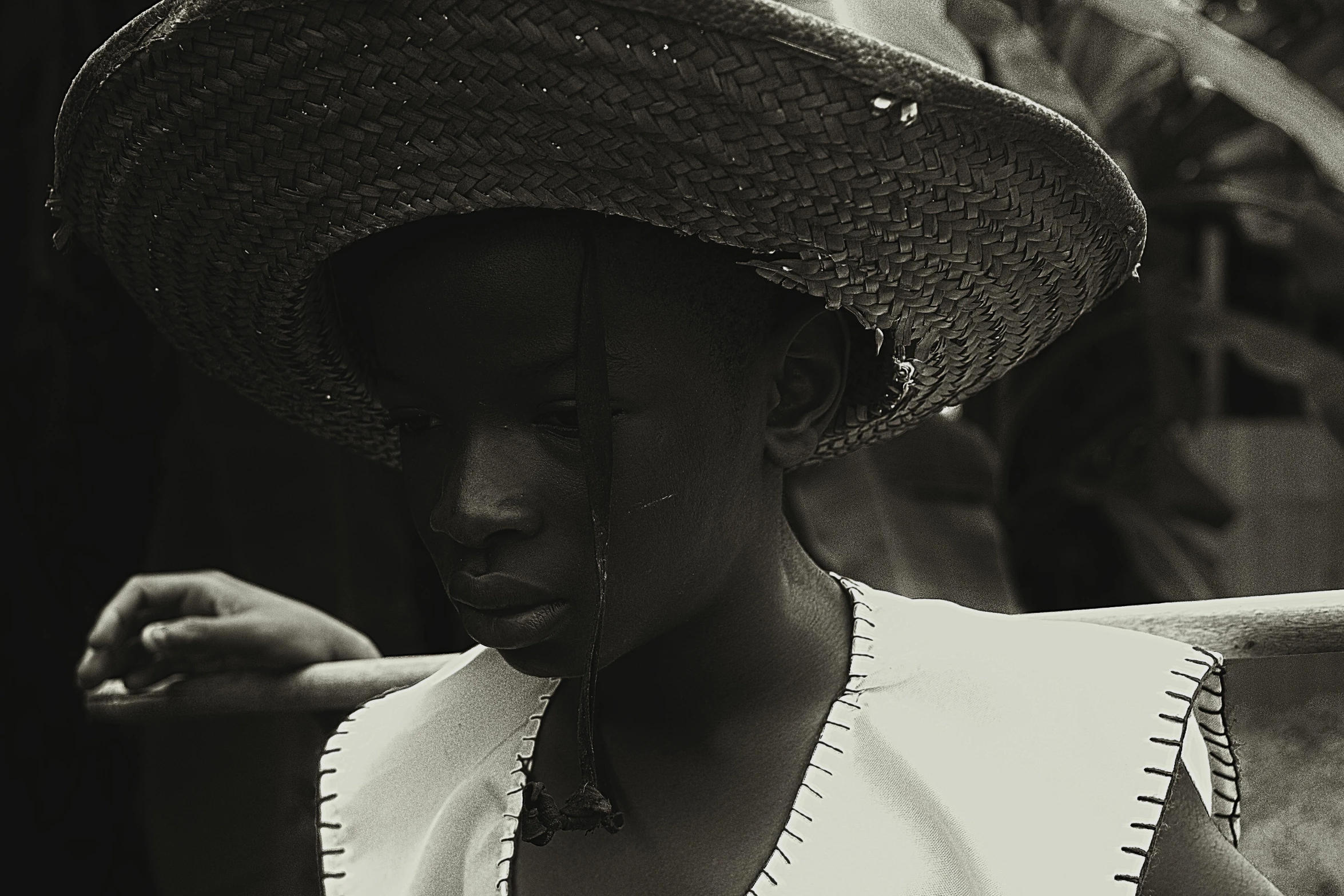 black and white pograph of a woman wearing a large hat