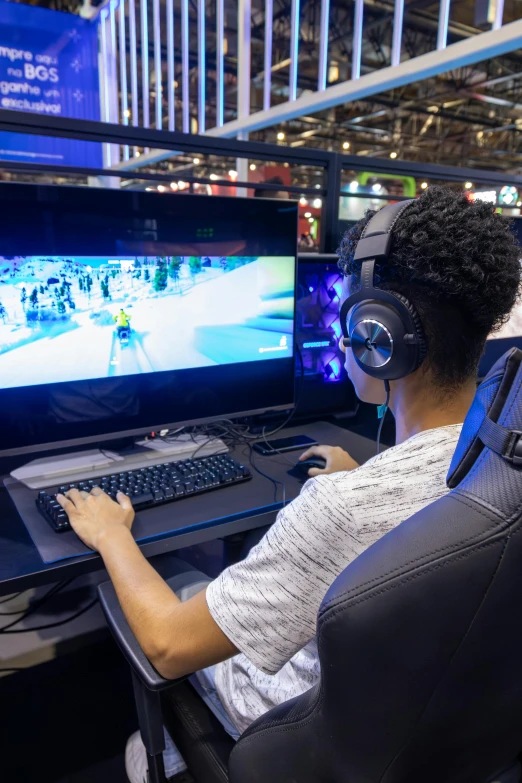 person with headphones on playing video games on the screen