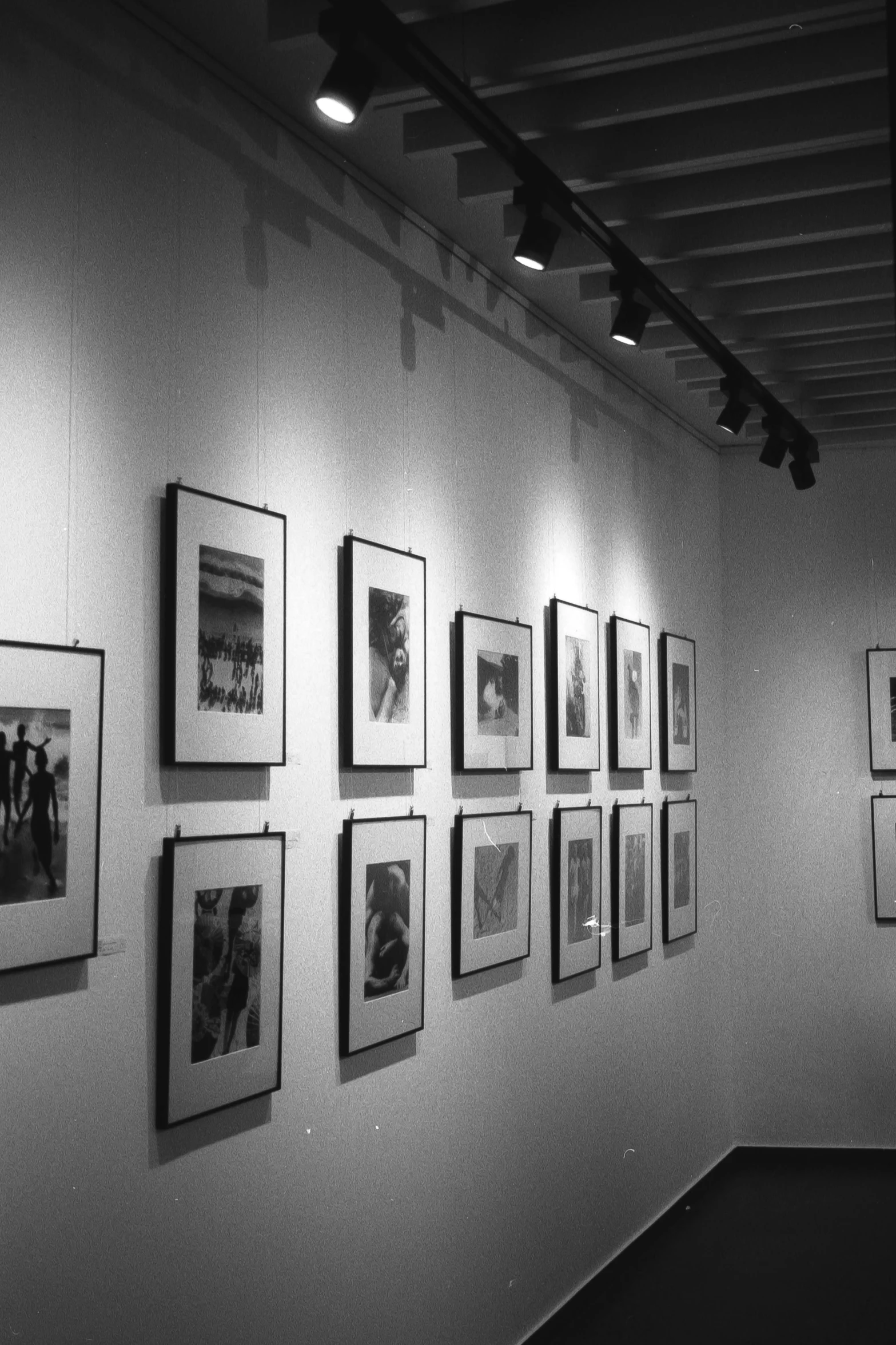 black and white po of many framed pographs on the wall