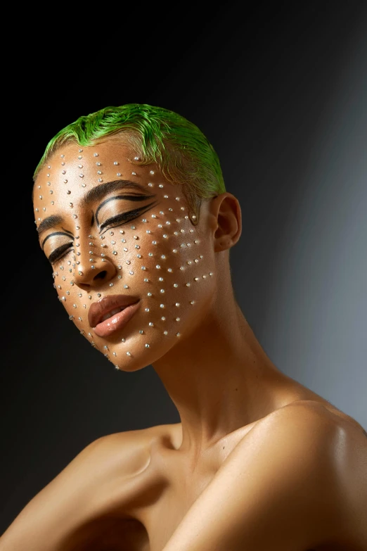 woman with green hair and white dots on her face