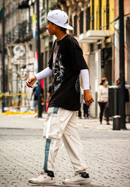 a skateboarder riding on the road next to a building