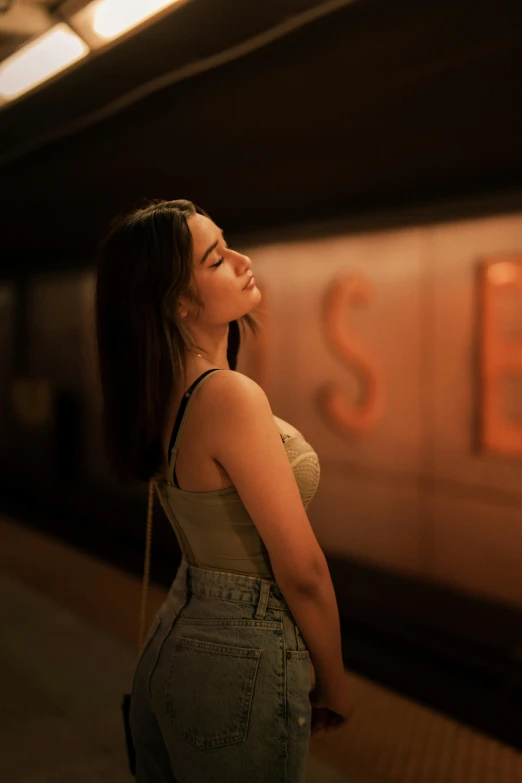 a woman waits for a train on the platform