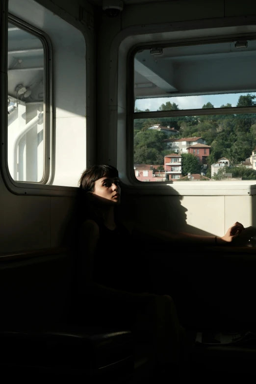 a woman sitting on a bus looking out the window