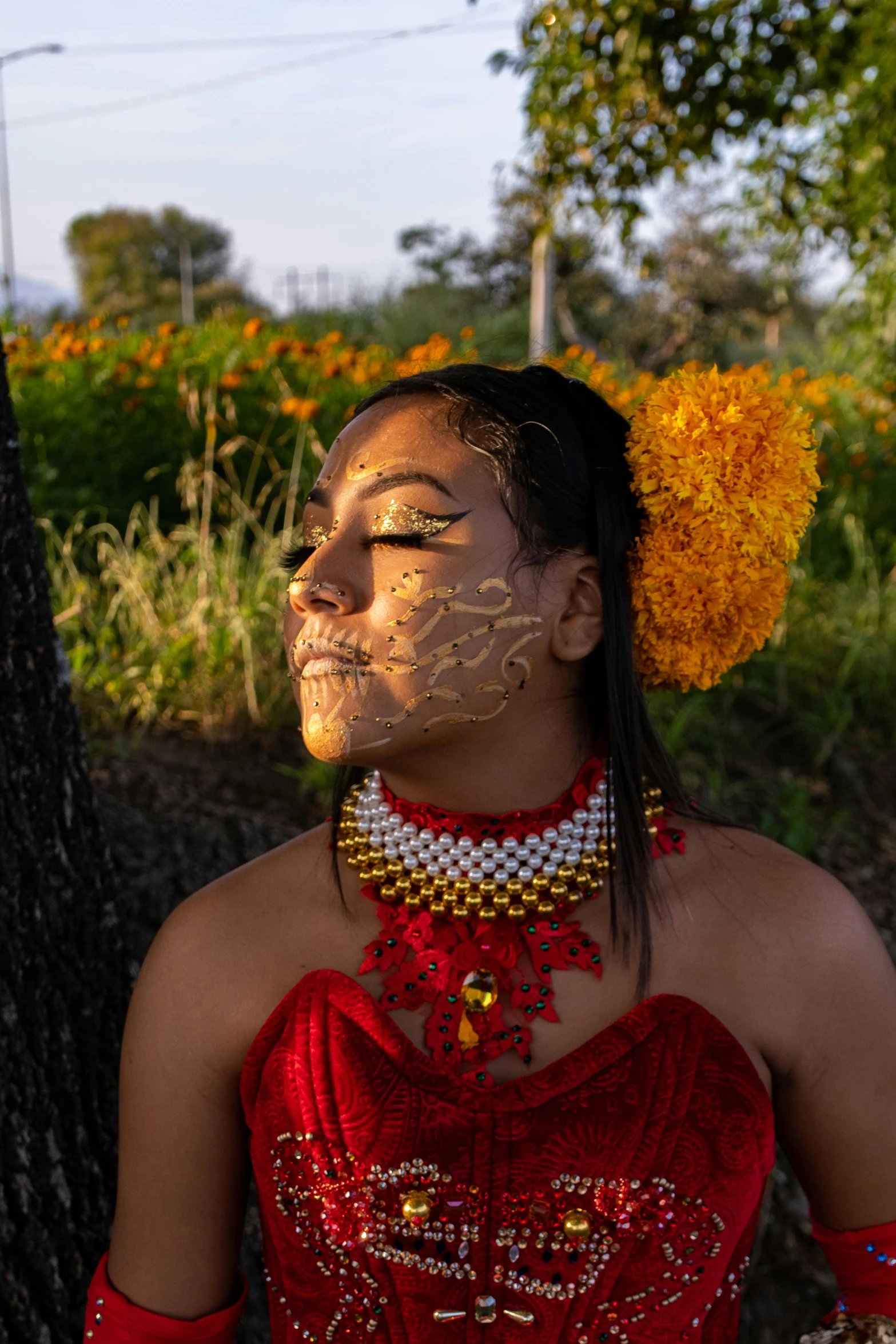 a woman in red dress wearing a headpiece