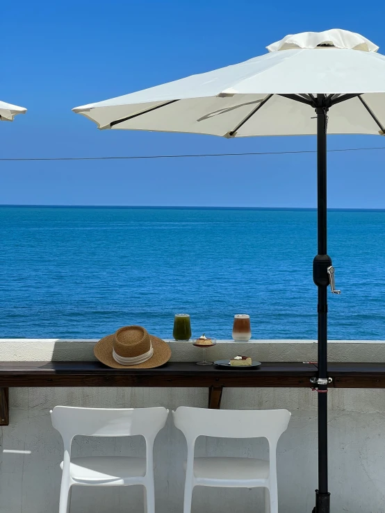 chairs and an umbrella are set up on a ledge