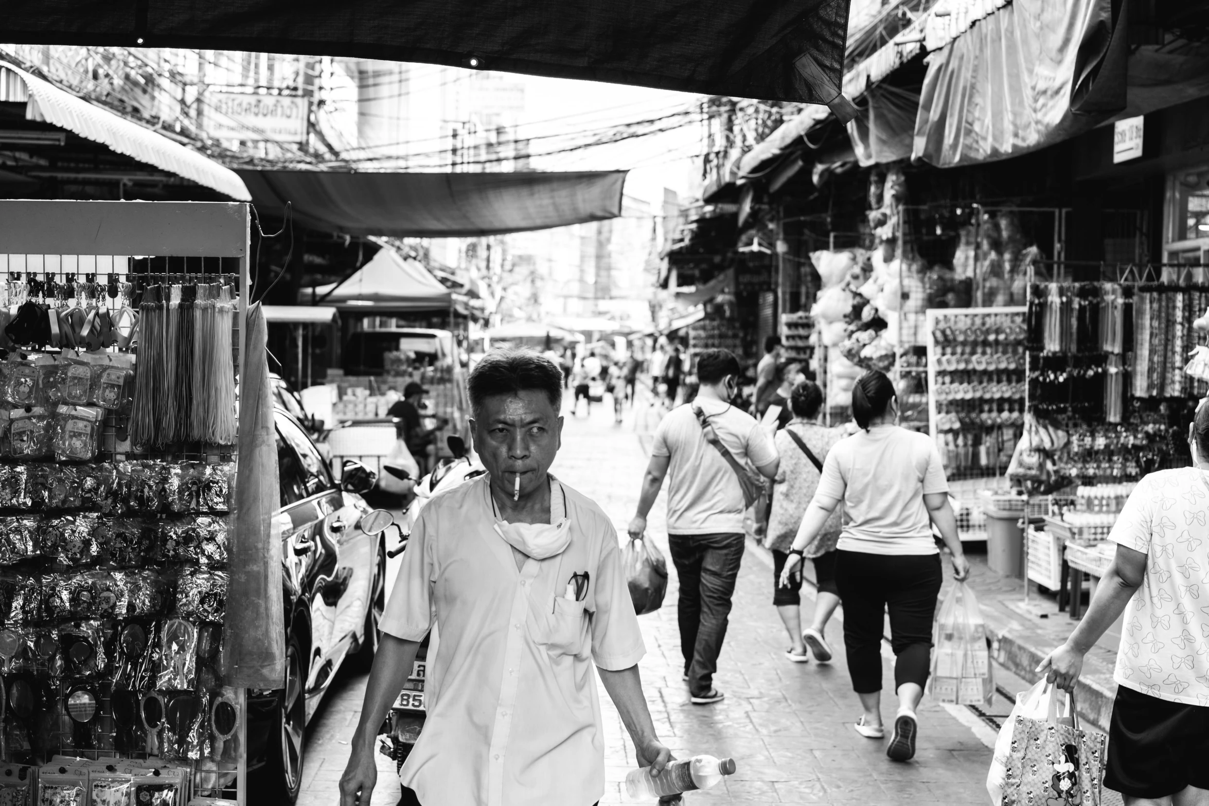 a black and white po of people walking down a street