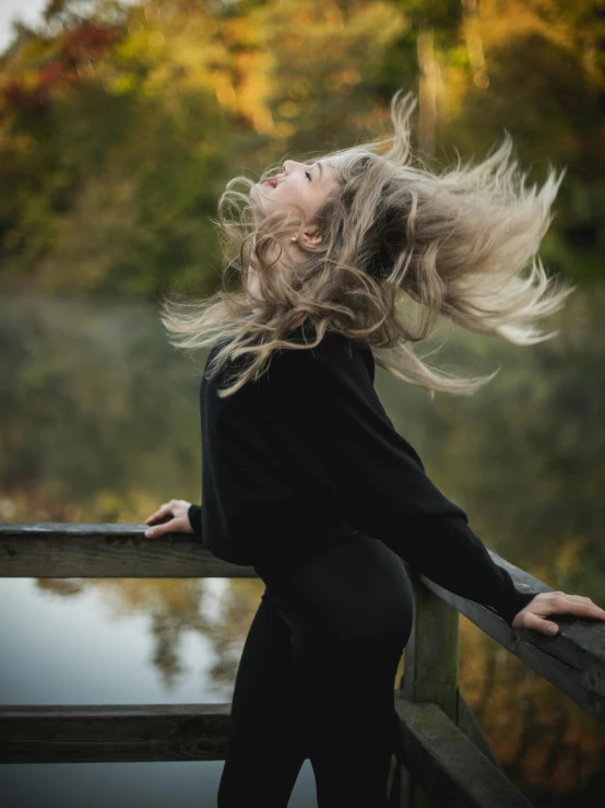 a woman is leaning over a railing outside