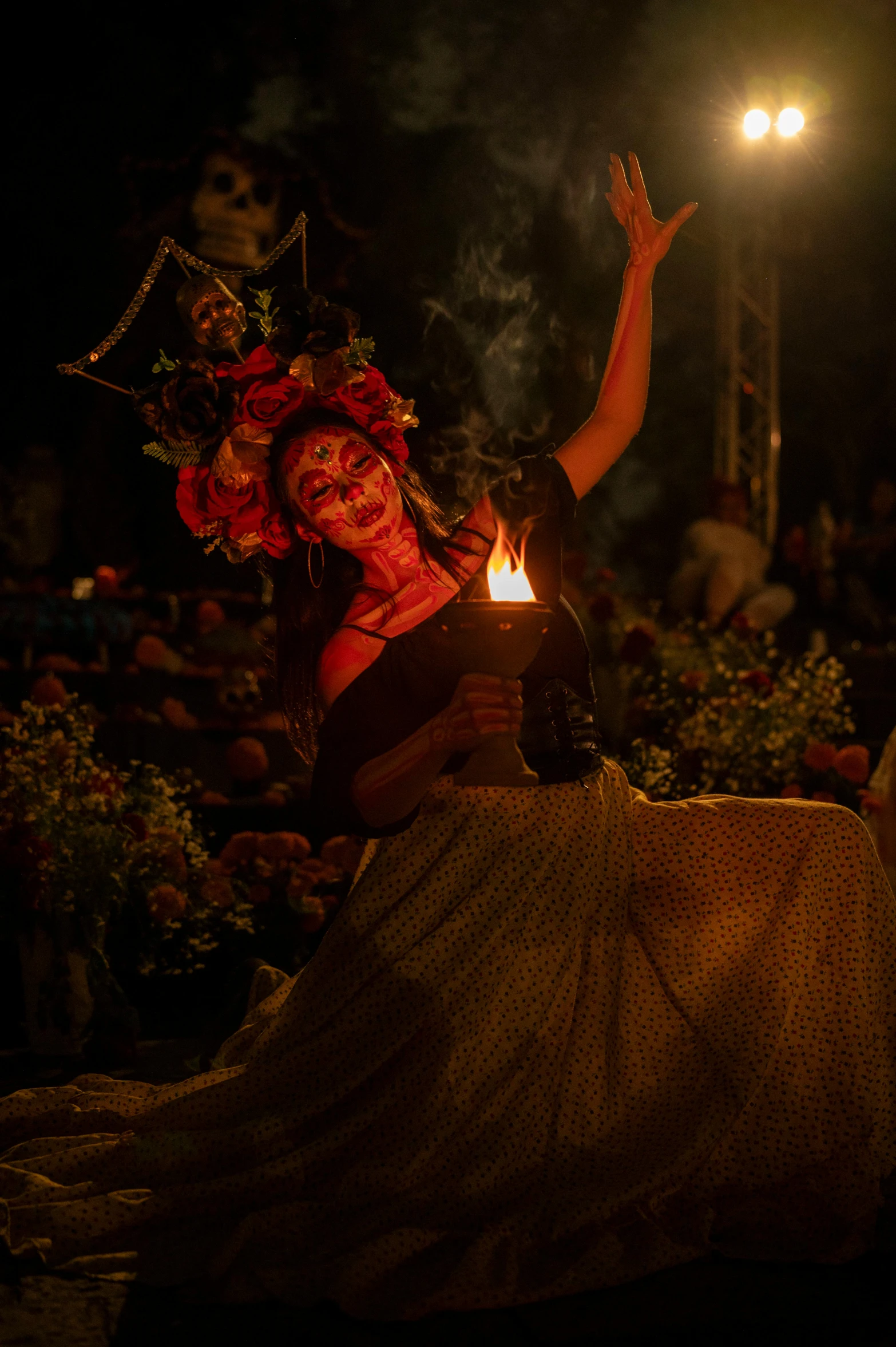 a woman dressed in costume holding up a lit candle