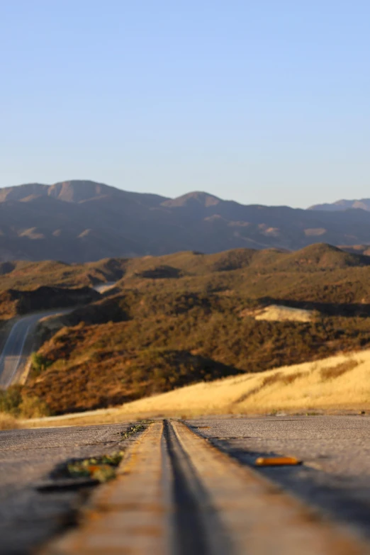 an old road with a mountain in the background