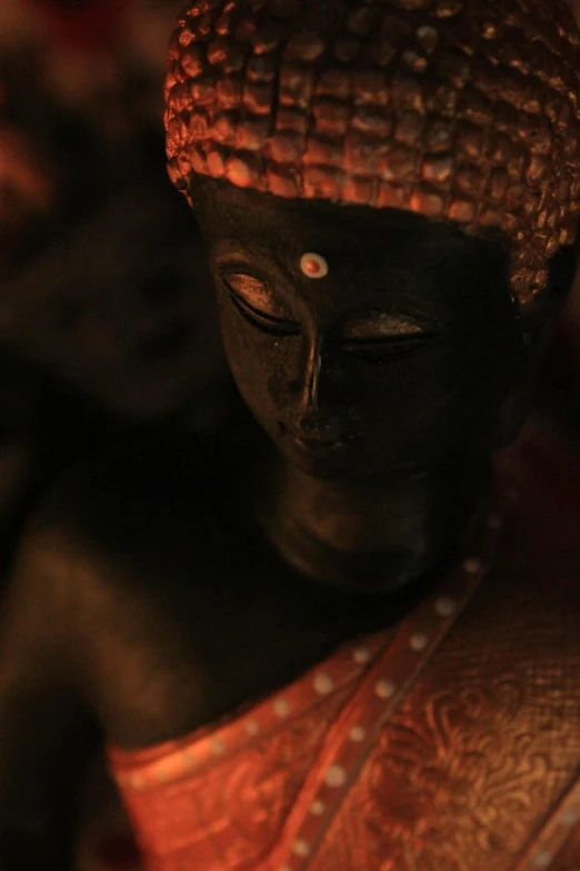 the statue of buddha with very little white dots