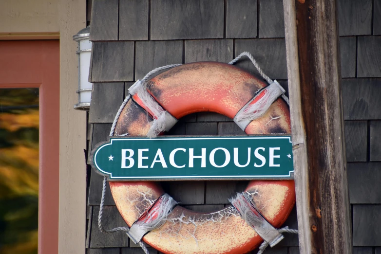 a green sign above a wreath hanging from a building