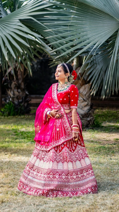 a woman standing by some palm trees in a dress