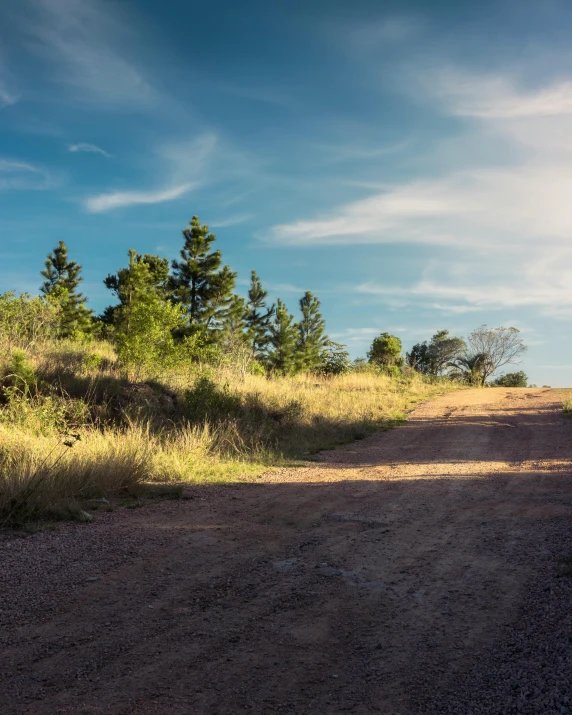 a rural road with two cars on it