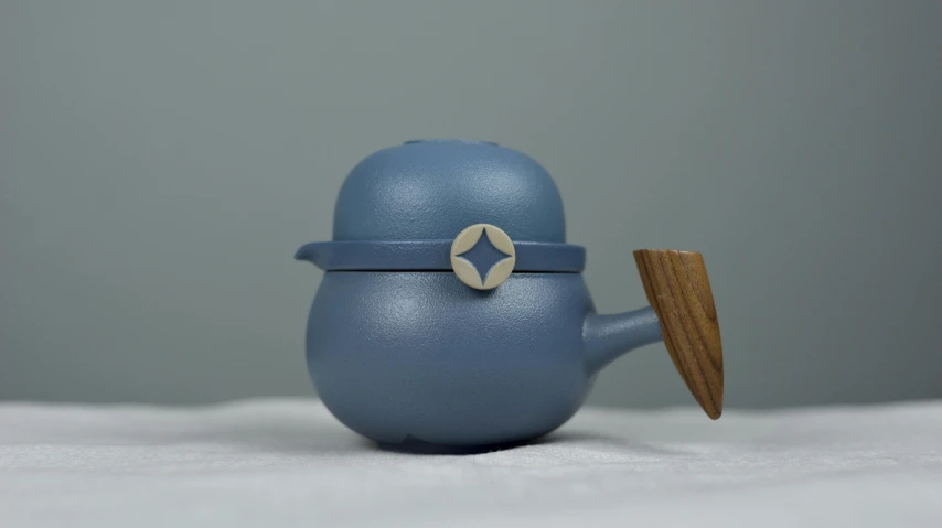 a blue toy with a wooden lid and spoon