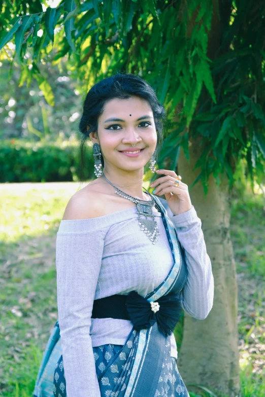 a smiling young woman is dressed in an indian clothing