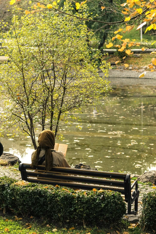 a couple of people sit on top of a bench