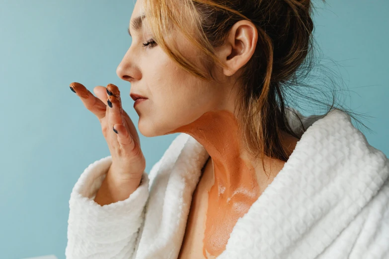 a woman is holding her hand up to her face