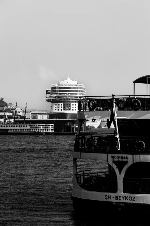 a river boat floating down a river next to a large city