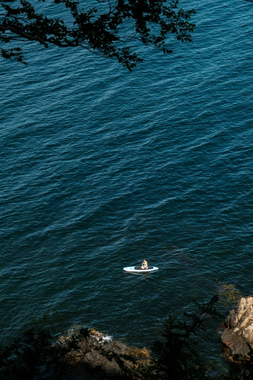 the man is lying down on his stomach in the ocean