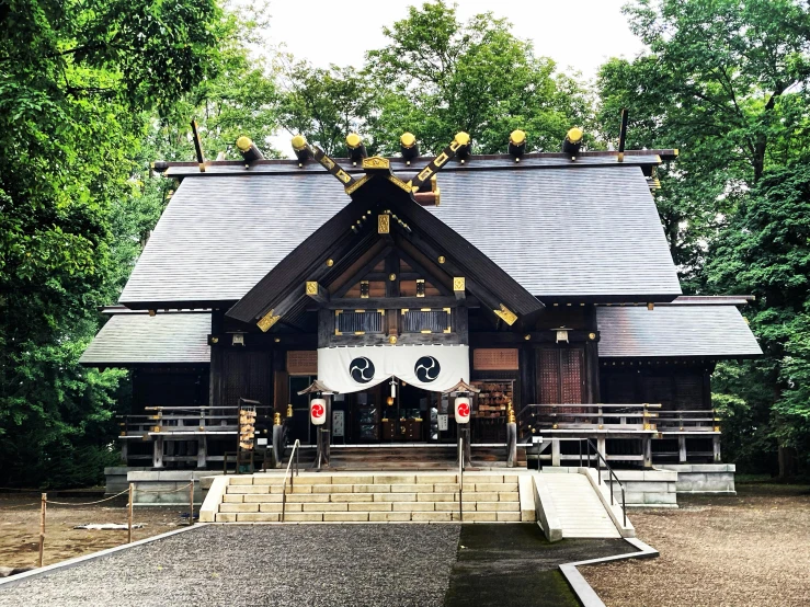 a temple structure in a park in the daytime