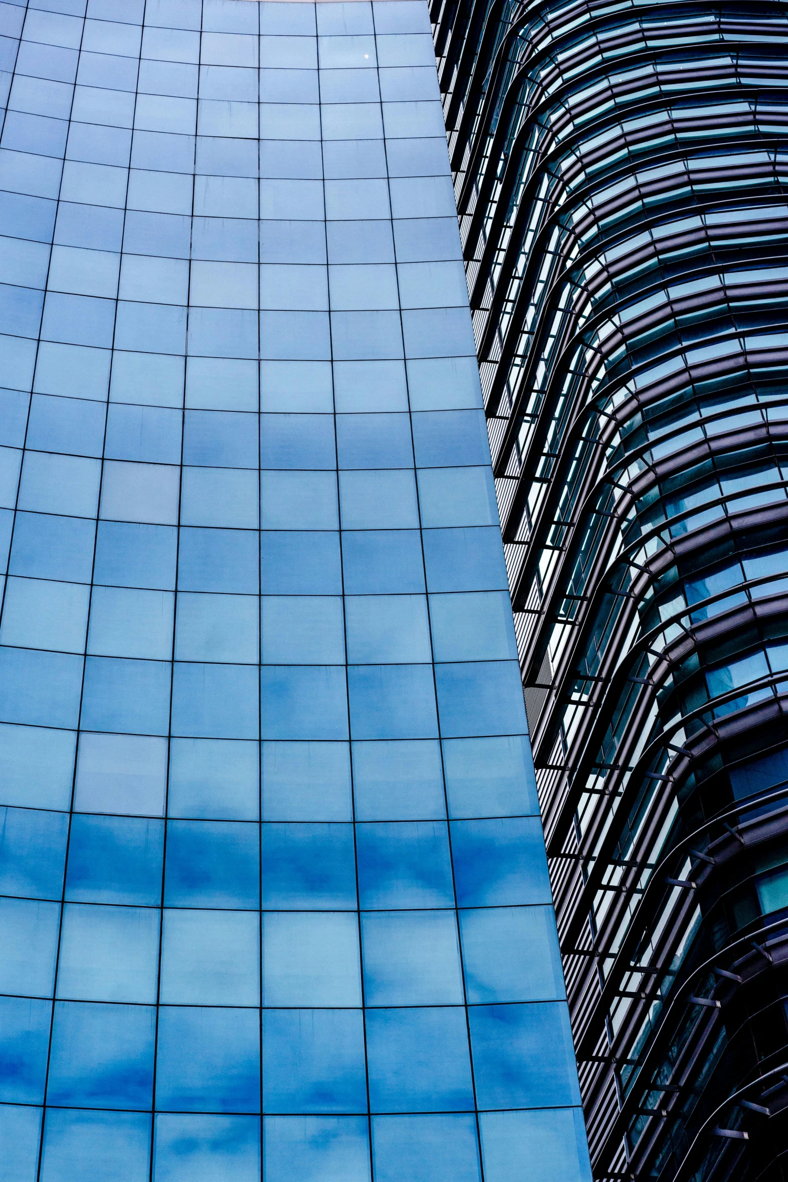 a high rise building with blue bricked facades