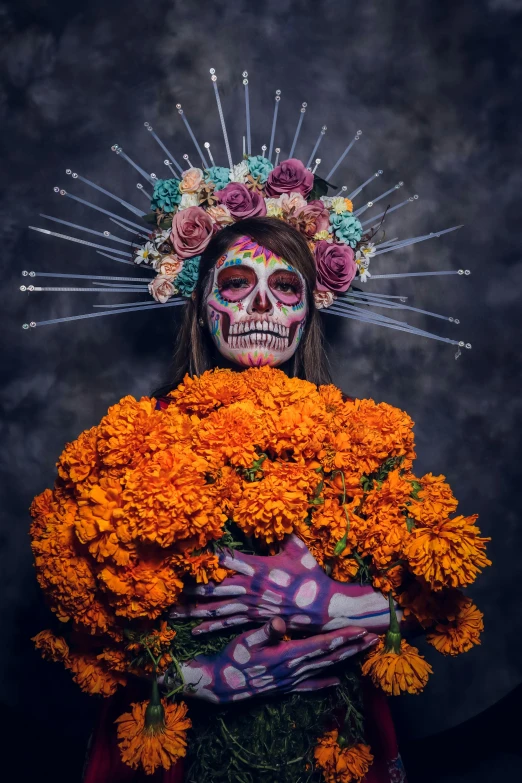 a girl with skulls and flowers on her face holding onto a bouquet