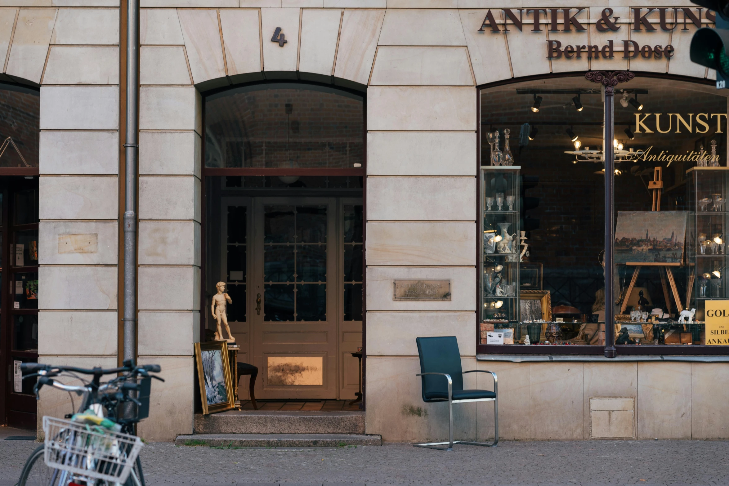 there is a shop front with a bicycle parked outside it