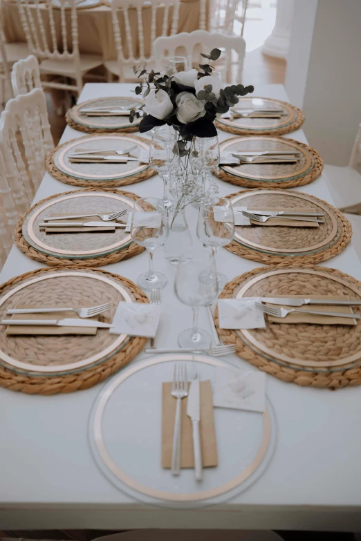 a table is set with place settings and place settings for a formal meal