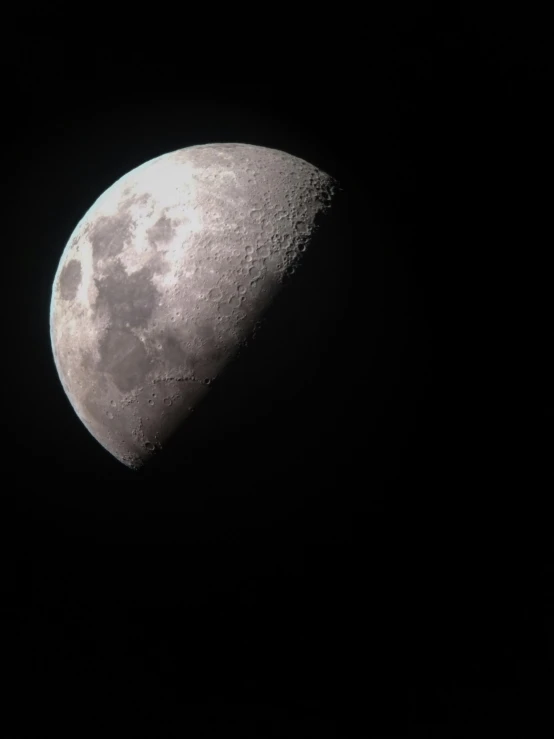 half moon with dark background seen from below