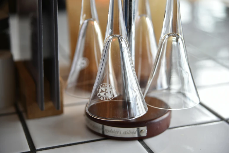 a group of four glass cone holders sitting on top of a table