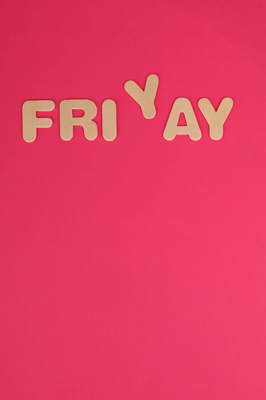 a pink surface with white and beige wooden word friday cut out of wood