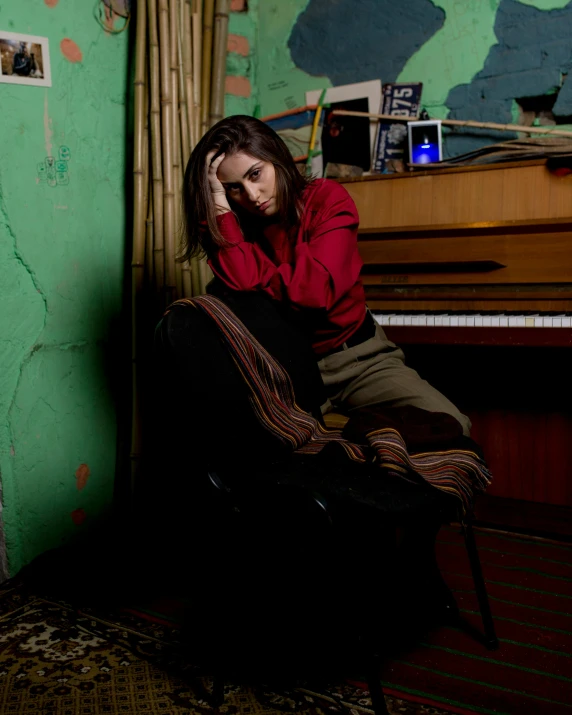 a woman sitting down talking on a phone